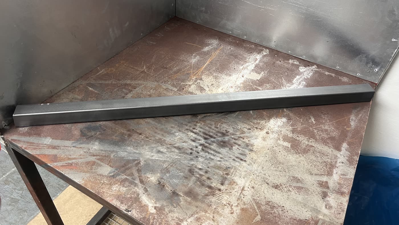 The same steel section stripped back to bare metal