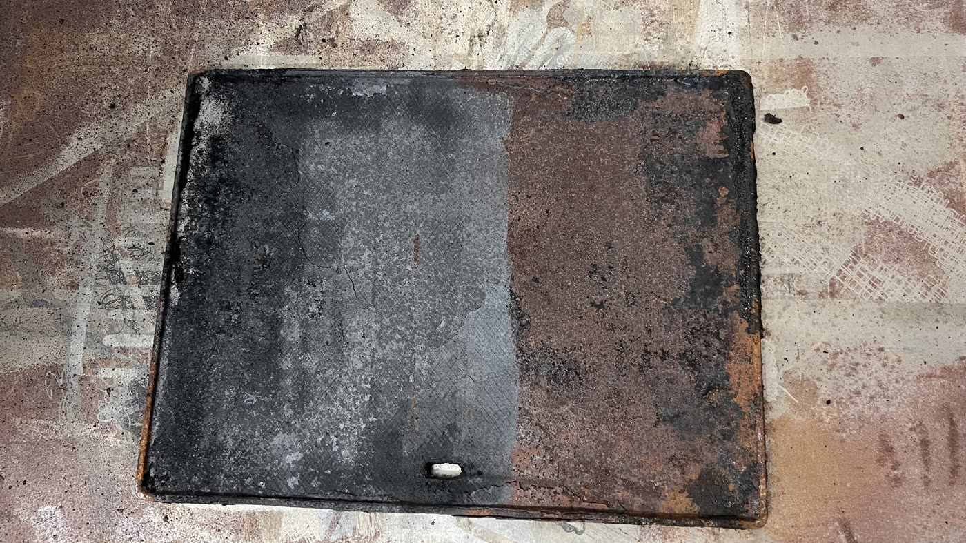 Rusted steel plate, left half laser cleaned to bare metal, right half untouched