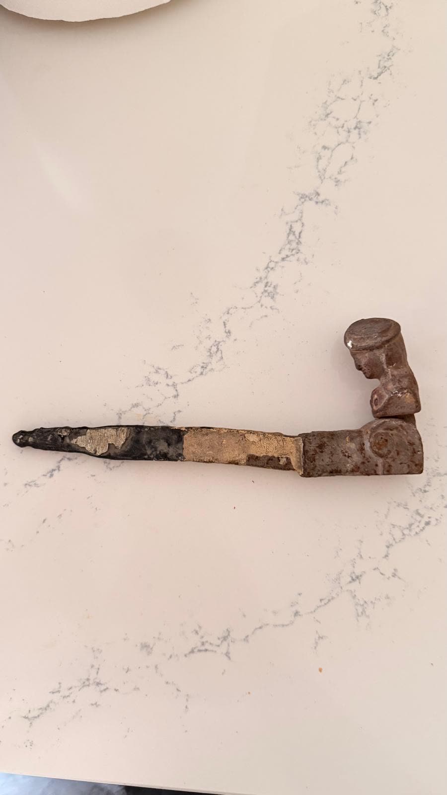 Cast iron window shutter hinge before cleaning, heavily rusted