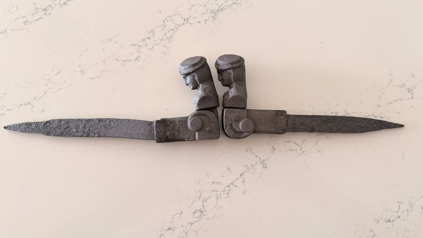 Both cast iron shutter hinges cleaned back to bare metal, figured heads clearly visible